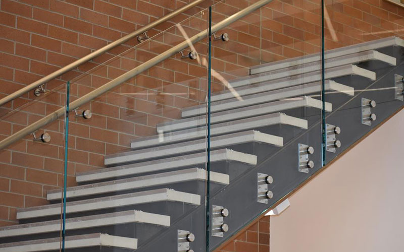 metal staircase with a glass wall rail